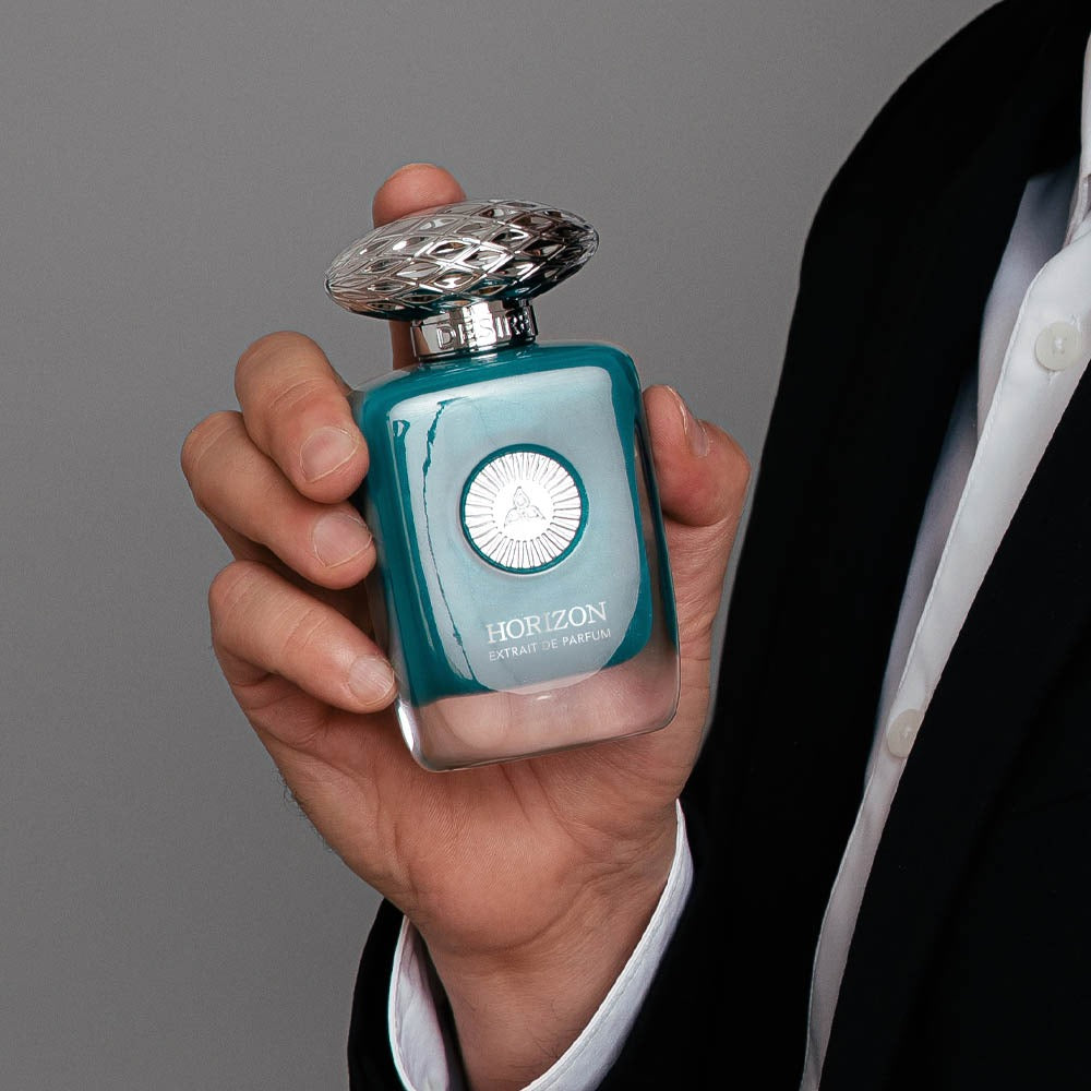 A man wearing a black suit holding Horizon by Savia Exclusive