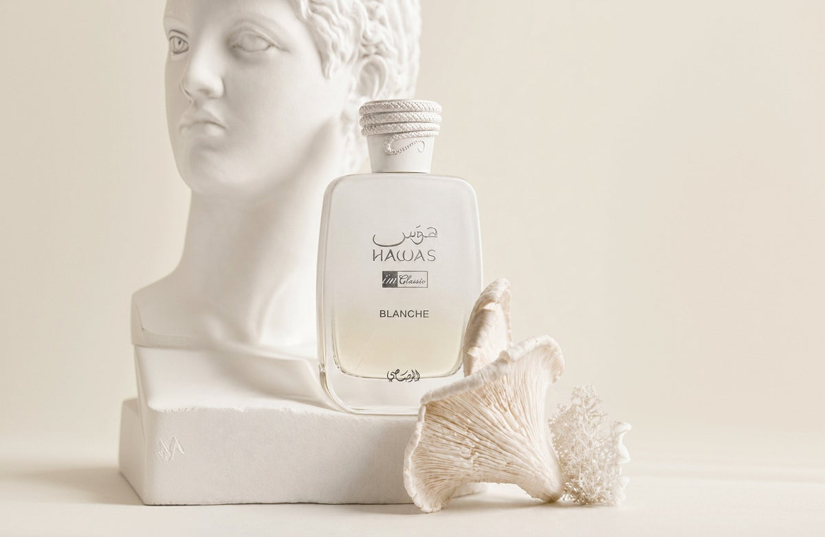 The bottle beside a bust and white coral